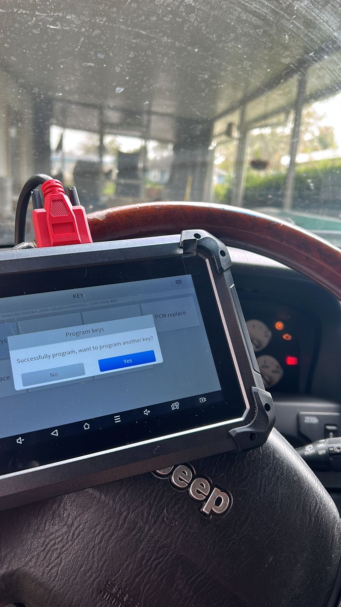 A car key programmed at the vehicle through the OBD port